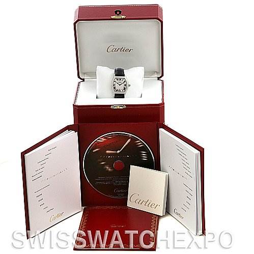 The image shows a Cartier Tortue W1546151 Platinum Silver Dial W1546151 Platinum Silver Dial watch in its open box, accompanied by a CD, manuals, and documents.