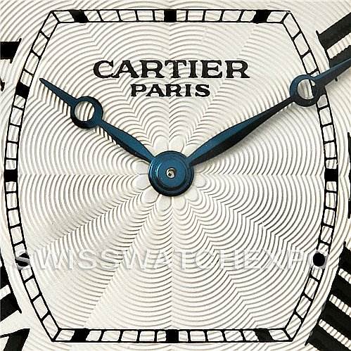 The image shows a close-up of the dial and hands of the Cartier Tortue W1546151 Platinum Silver Dial W1546151 Platinum Silver Dial watch, highlighting the intricate guilloché pattern.