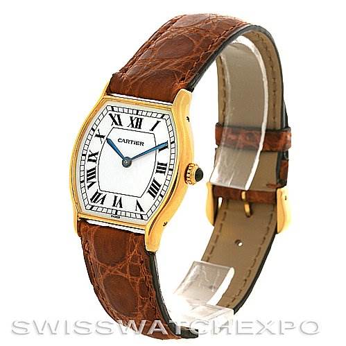 The image shows a Cartier Tortue Women's Yellow Gold White Dial Women's Yellow Gold White Dial watch from a front angle displaying the face, leather strap, buckle, and crown.
