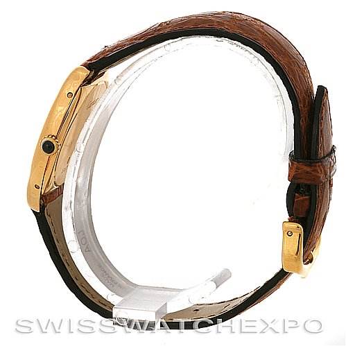 The image shows a side view of the Cartier Tortue Women's Yellow Gold White Dial Women's Yellow Gold White Dial watch, highlighting the case, crown, and brown leather strap.