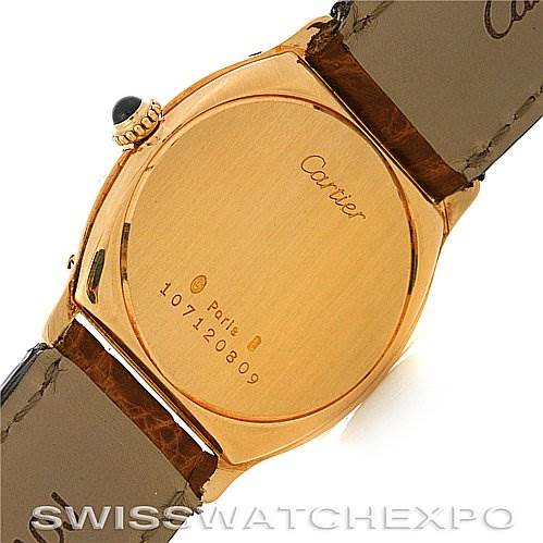 The image shows the back case and part of the strap of a Cartier Tortue Women's Yellow Gold White Dial Women's Yellow Gold White Dial model watch.