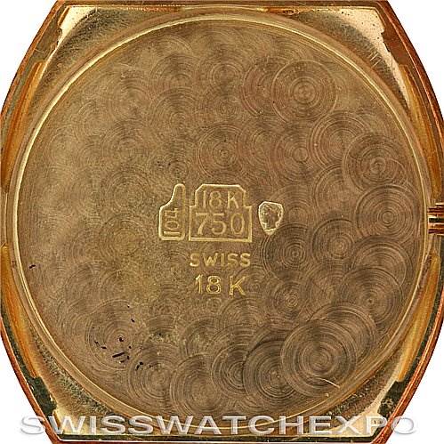 The image shows the back case of a Cartier Tortue Women's Yellow Gold White Dial Women's Yellow Gold White Dial watch, displaying "18K 750" and "Swiss 18K" engravings.