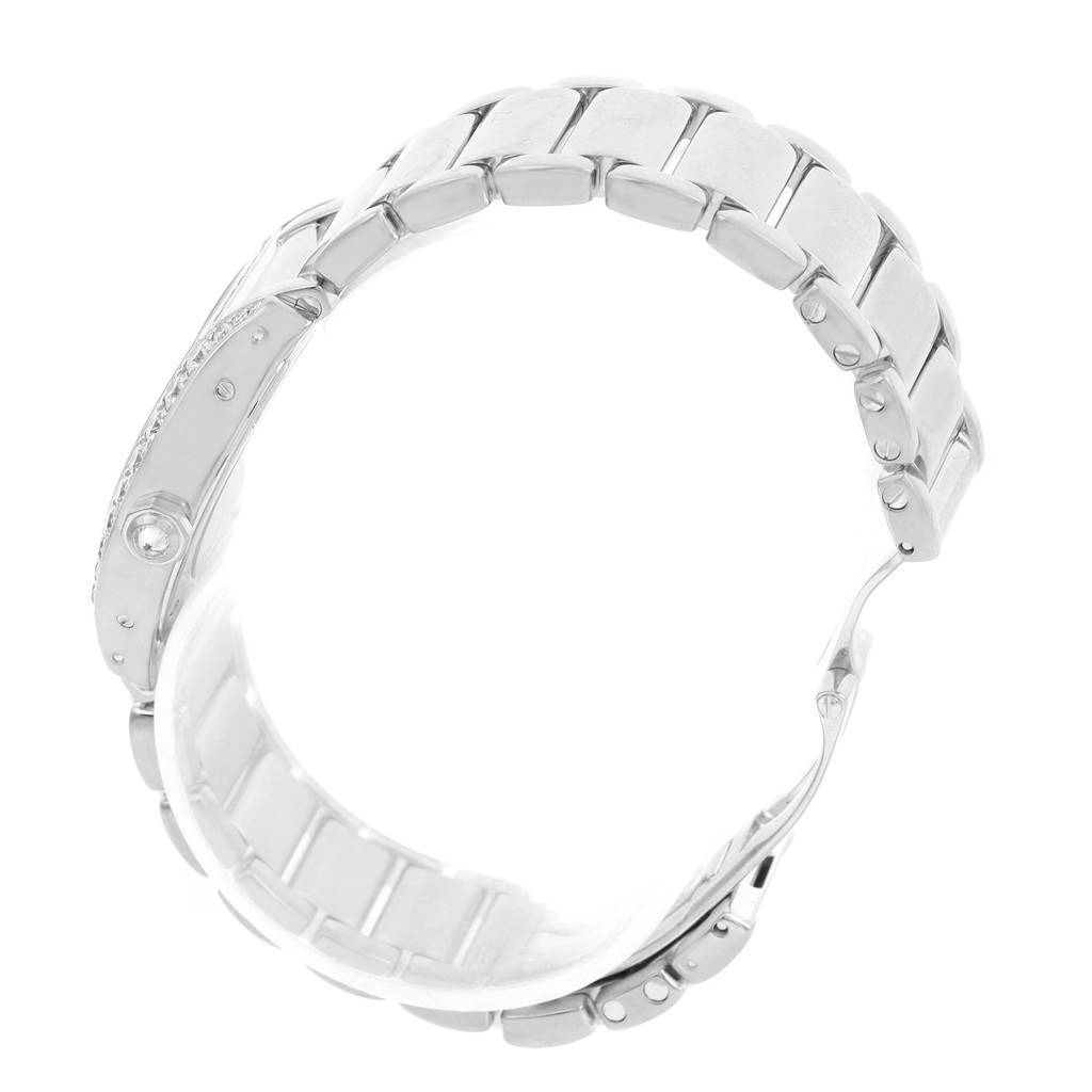 This image shows the Tortue model watch by Cartier from a top-down angle, focusing on its metal bracelet and case side.