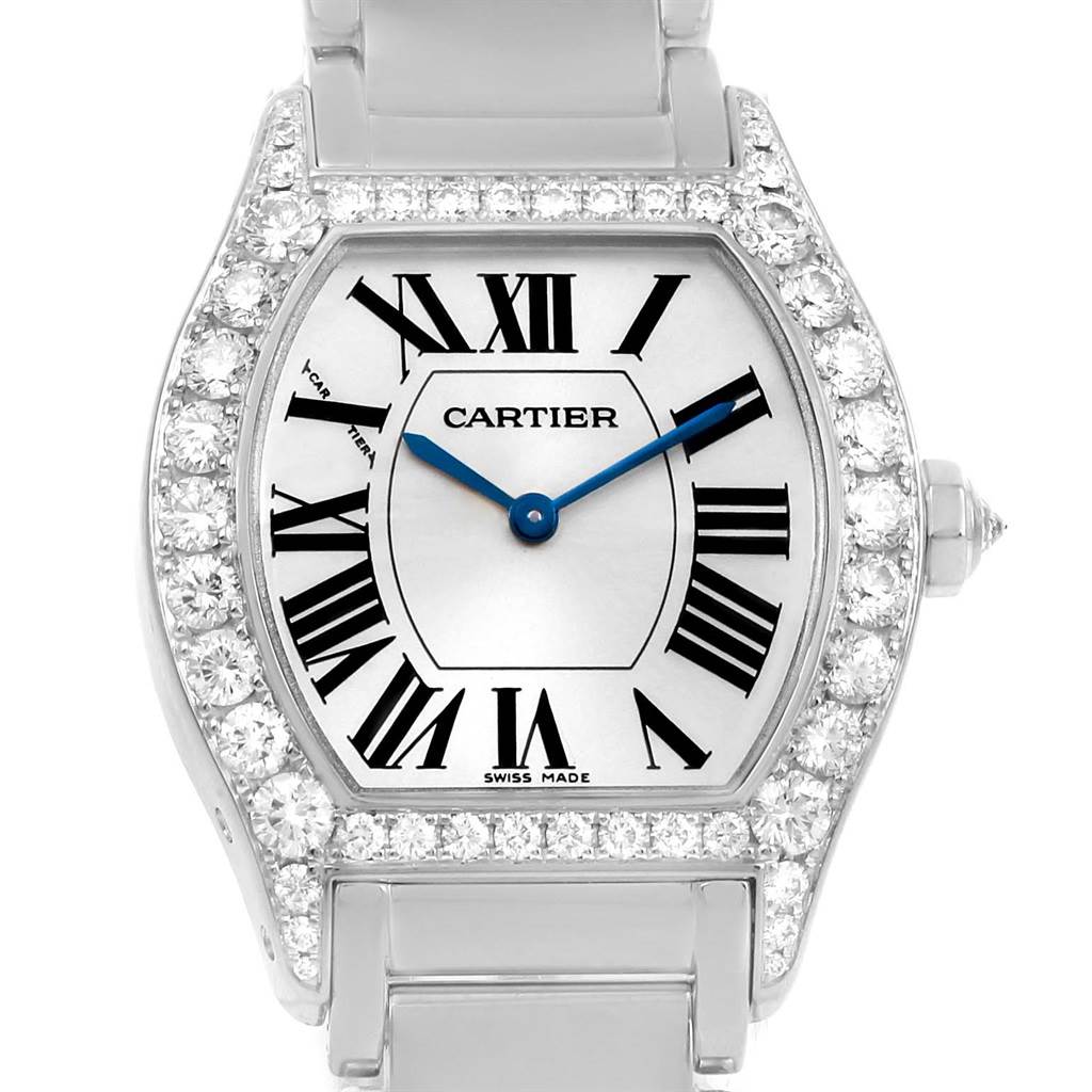The image shows a front view of a Cartier Tortue WA5072W9 Women's White Gold Silver Dial WA5072W9 Women's White Gold Silver Dial watch, highlighting the dial, Roman numerals, blue hands, and diamond-encrusted bezel.