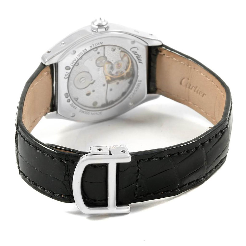 The image shows the back of a Cartier Tortue watch, highlighting the movement, case back, and leather strap with a buckle.