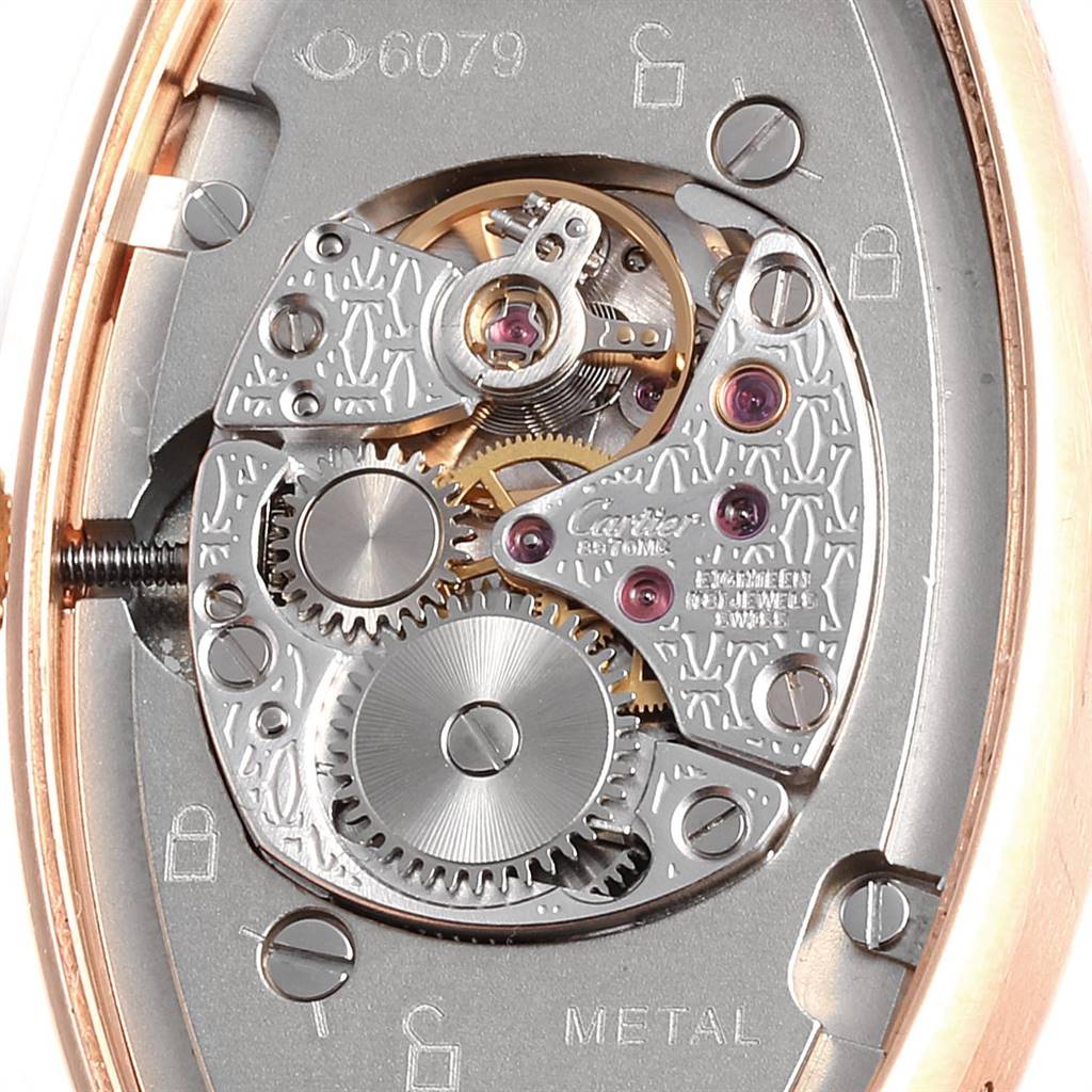 This image shows a close-up view of the movement of a Cartier Tortue WE400331 Women's Yellow Gold Silver Dial WE400331 Women's Yellow Gold Silver Dial watch, highlighting its gears and internal mechanisms.