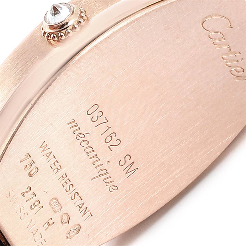 This image shows a close-up of the case back and crown of a Cartier Tortue WE400331 Women's Yellow Gold Silver Dial WE400331 Women's Yellow Gold Silver Dial model watch.