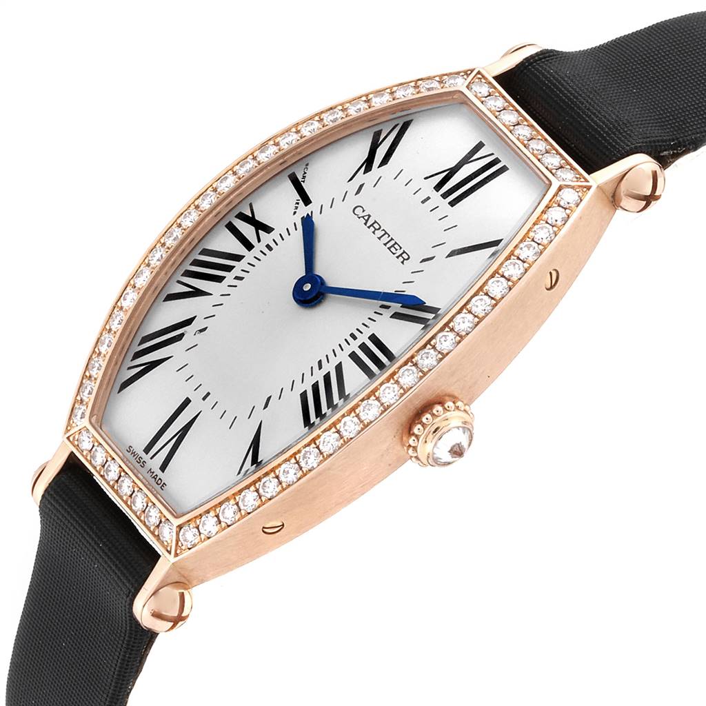 The Cartier Tortue WE400331 Women's Yellow Gold Silver Dial WE400331 Women's Yellow Gold Silver Dial watch is shown at a front-angle view, highlighting its diamond bezel, Roman numeral dial, and crown with a gemstone.