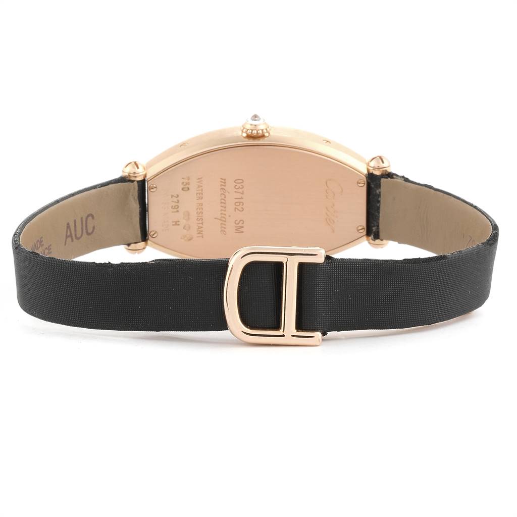 This image shows the back view of a Tortue model watch by Cartier, highlighting the caseback and black strap.