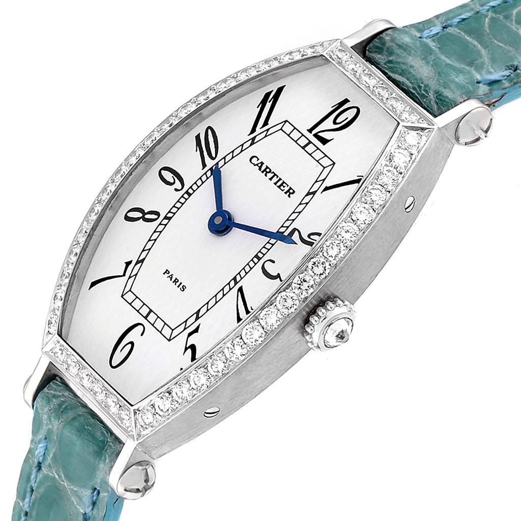 The image shows a Cartier Tortue WE400131 Women's White Gold White Dial WE400131 Women's White Gold White Dial watch at an angle showcasing the dial, bezel, crown, and part of the strap.