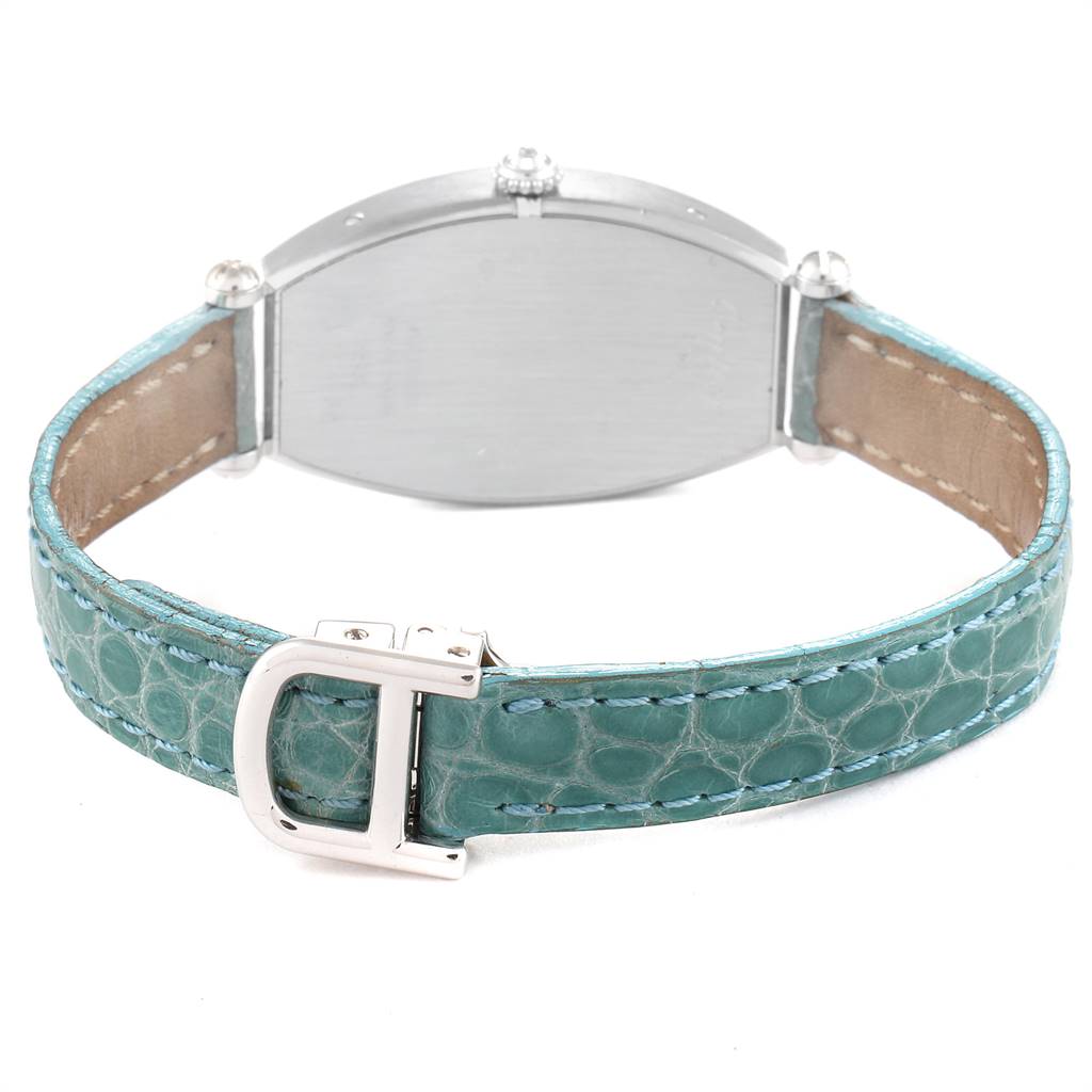 This image shows the back of a Cartier Tortue WE400131 Women's White Gold White Dial WE400131 Women's White Gold White Dial watch and its green leather strap with a metal buckle.