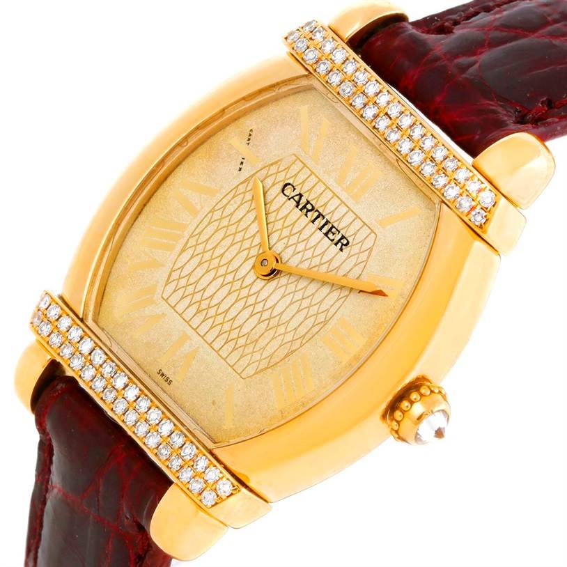 The image shows a close-up, angled view of a Cartier Tortue Women's Yellow Gold Champagne Dial Women's Yellow Gold Champagne Dial watch, highlighting the face, bezel, and leather strap.