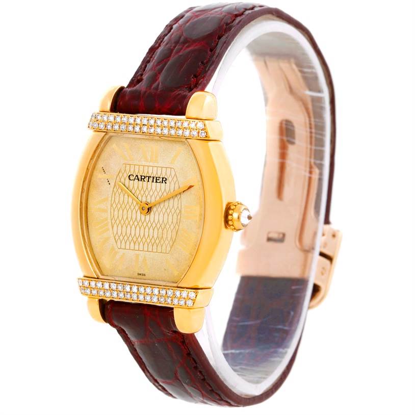 The image shows a Cartier Tortue Women's Yellow Gold Champagne Dial Women's Yellow Gold Champagne Dial model watch with a gold case, diamond bezel, and brown leather strap from a side angle.