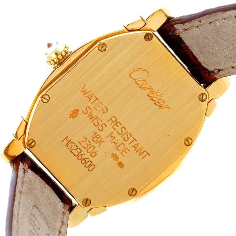 The image shows the case back of the Cartier Tortue Women's Yellow Gold Champagne Dial Women's Yellow Gold Champagne Dial watch, highlighting engravings and the screw-down back.