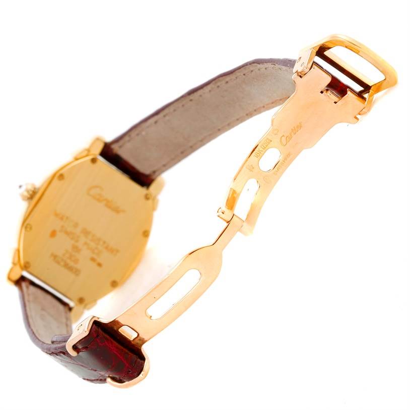 The image shows the back and clasp of the Cartier Tortue Women's Yellow Gold Champagne Dial Women's Yellow Gold Champagne Dial watch, highlighting the gold case and leather strap.
