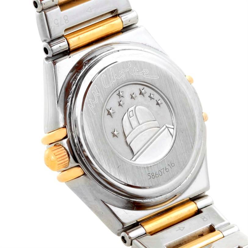 The image shows the back case and part of the bracelet of the Omega 1365.75.00 Women
s Steel and Gold (two tone) Mother of Pearl Dial 1365.75.00 Women
s Steel and Gold (two tone) Mother of Pearl Dial Constellation Mini Steel Yellow Gold Diamond Watch 1365.75.00.