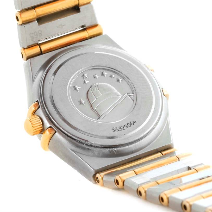 The image shows the back of an Omega 1267.75.00 Women
s Steel and Gold (two tone) Mother of Pearl Dial 1267.75.00 Women
s Steel and Gold (two tone) Mother of Pearl Dial Constellation My Choice Mini Steel Gold Diamond Watch 1267.75.00, including parts of the bracelet and crown.