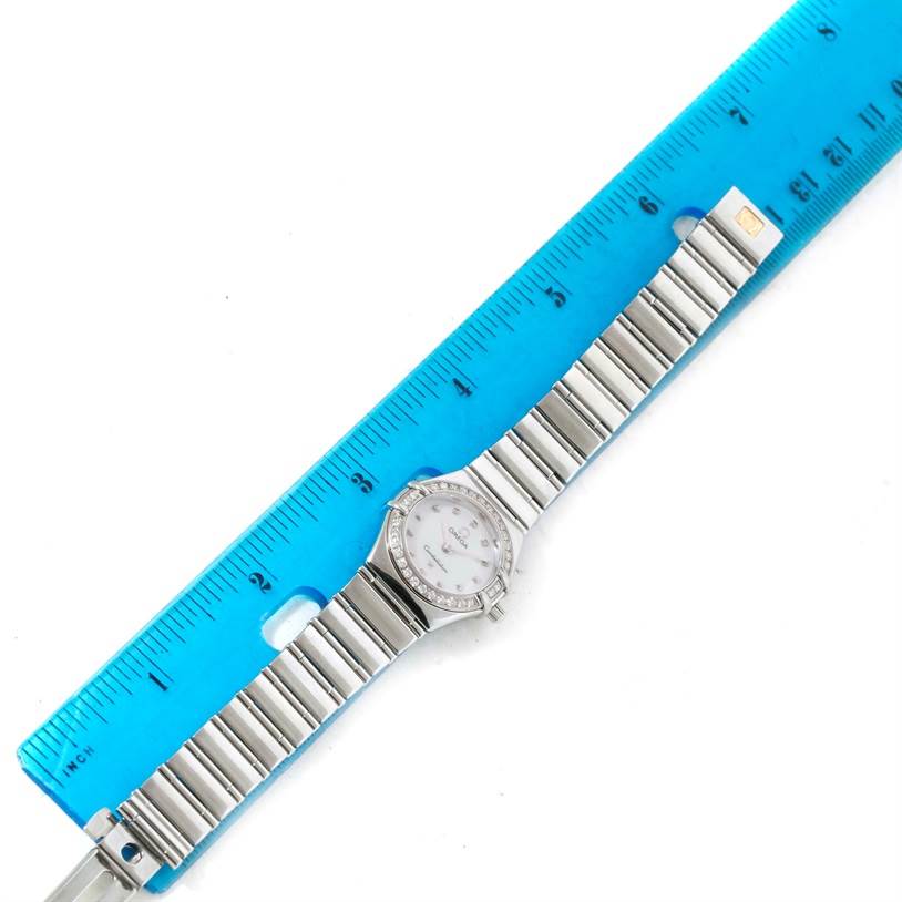 The Omega 1465.71.00 Women's Stainless Steel Mother of Pearl Dial 1465.71.00 Women's Stainless Steel Mother of Pearl Dial Constellation My Choice Ladies Mini Watch 1465.71.00 is shown from a top view, with a ruler for scale.