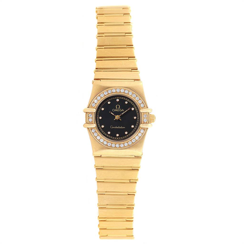 The image shows a frontal view of an Omega 1164.75.00 Women's Yellow Gold Black Dial 1164.75.00 Women's Yellow Gold Black Dial Constellation 18K Yellow Gold Diamond Ladies Watch model 1164.75.00 with a gold bracelet and diamond bezel.