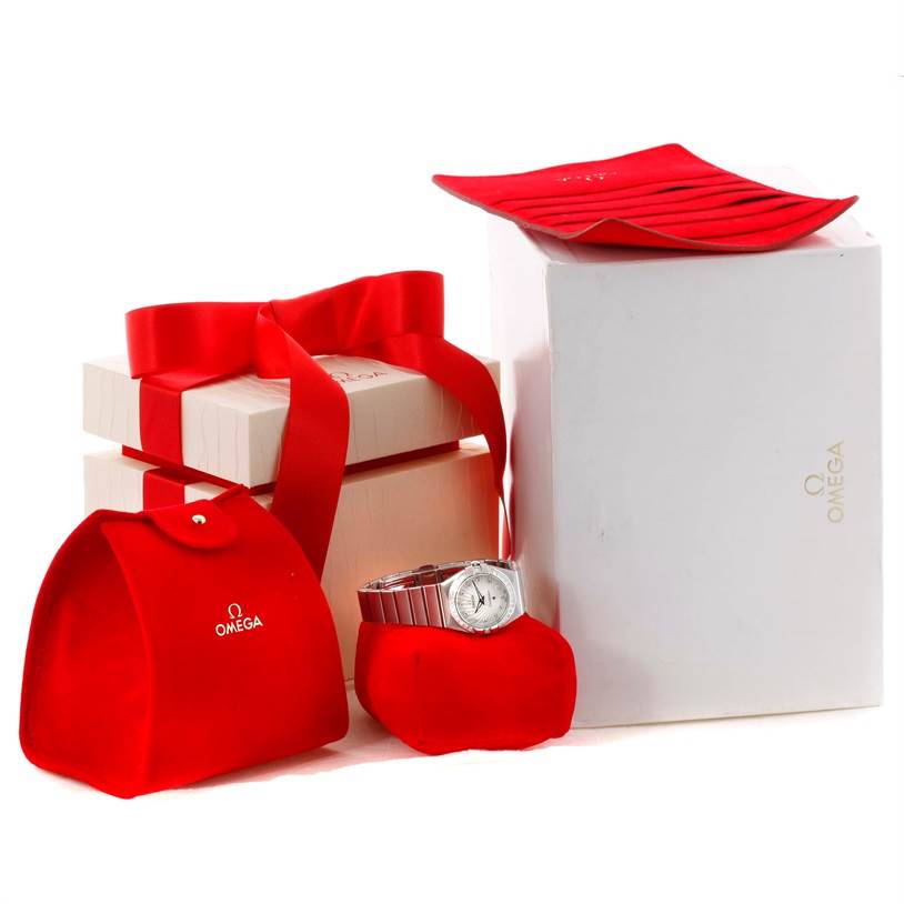 The image shows the Omega 123.15.27.60.55.002 Women
s Stainless Steel Mother of Pearl Dial 123.15.27.60.55.002 Women
s Stainless Steel Mother of Pearl Dial Constellation 27mm Diamond Watch model 123.15.27.60.55.002 with gift boxes and red Omega 123.15.27.60.55.002 Women
s Stainless Steel Mother of Pearl Dial 123.15.27.60.55.002 Women
s Stainless Steel Mother of Pearl Dial pouches.