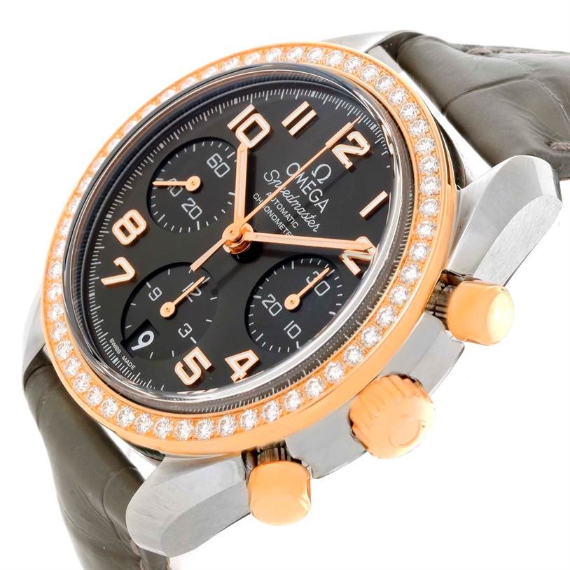 The image shows an angled, close-up view of the Omega 324.28.38.40.06.001 Men's Steel and Gold (two tone) Grey Dial 324.28.38.40.06.001 Men's Steel and Gold (two tone) Grey Dial Speedmaster Chronograph Diamond Watch 324.28.38.40.06.001 with its dial, bezel, and crown.