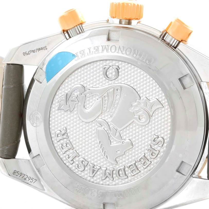 The image shows the case back and crown of an Omega 324.28.38.40.06.001 Men's Steel and Gold (two tone) Grey Dial 324.28.38.40.06.001 Men's Steel and Gold (two tone) Grey Dial Speedmaster Chronograph Diamond Watch 324.28.38.40.06.001 Unworn model.