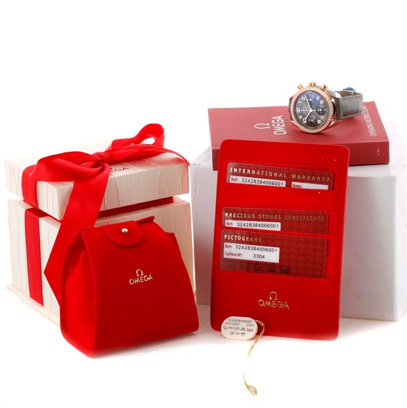 The Omega 324.28.38.40.06.001 Men's Steel and Gold (two tone) Grey Dial 324.28.38.40.06.001 Men's Steel and Gold (two tone) Grey Dial Speedmaster Chronograph Diamond Watch 324.28.38.40.06.001 is shown from an angled top view, along with its box, warranty card, and accessories.