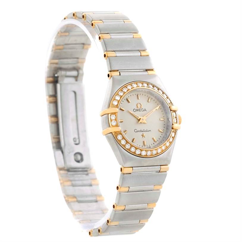 This image shows the Omega 1277.30.00 Women's Steel and Gold (two tone) Silver Dial 1277.30.00 Women's Steel and Gold (two tone) Silver Dial Constellation Mini Steel and Gold Textured Dial Diamond Watch 1277.30.00 at an angle displaying its face and bracelet.