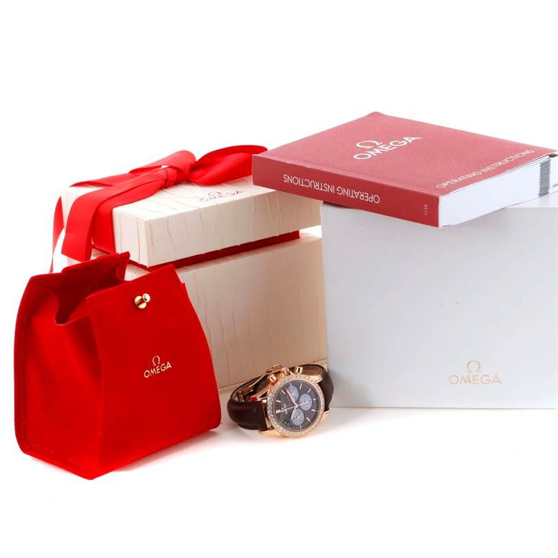 The image shows an Omega 4677.60.37 Women's Rose Gold Mother of Pearl Dial 4677.60.37 Women's Rose Gold Mother of Pearl Dial DeVille Co-Axial 18K Rose Gold Diamond Ladies Watch 4677.60.37 with its box, case, and instruction manual.