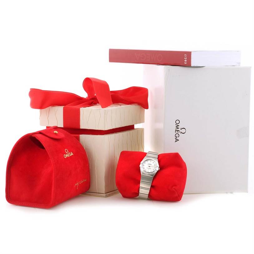 The image shows the Omega 123.15.27.60.55.002 Women
s Stainless Steel Mother of Pearl Dial 123.15.27.60.55.002 Women
s Stainless Steel Mother of Pearl Dial Constellation 27mm Diamond Ladies Watch model 123.15.27.60.55.002 with its packaging and accessories.