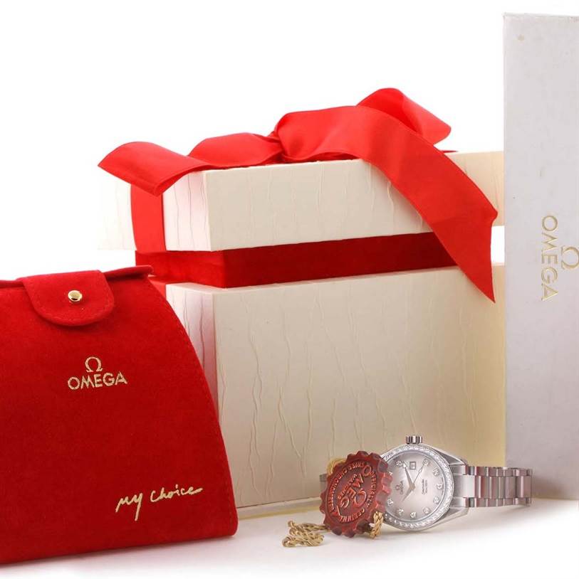 The image shows an Omega 2579.75 Women
s Stainless Steel Mother of Pearl Dial 2579.75 Women
s Stainless Steel Mother of Pearl Dial Aqua Terra 29mm Mother of Pearl Diamond Ladies Watch 2579.75 with its packaging and accessories.