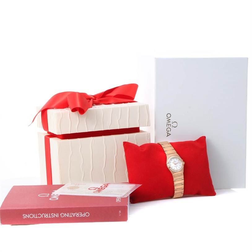The image shows an Omega 1167.75.00 Women's Rose Gold Mother of Pearl Dial 1167.75.00 Women's Rose Gold Mother of Pearl Dial Constellation 95 18K Rose Gold Diamond Watch model 1167.75.00 with its box, pillow cushion, manual, and card.