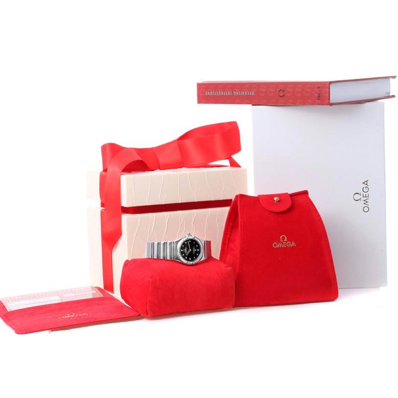 The image shows an Omega 1475.51.00 Women
s Stainless Steel Black Dial 1475.51.00 Women
s Stainless Steel Black Dial Constellation My Choice Ladies Diamond Watch 1475.51.00 with its box, pouch, and instructional manual.