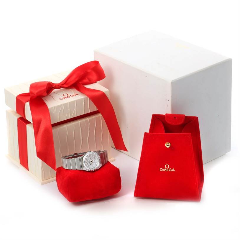 The Omega 123.15.27.60.52.001 Women
s Stainless Steel Silver Dial 123.15.27.60.52.001 Women
s Stainless Steel Silver Dial Constellation 27mm Diamond Ladies Watch 123.15.27.60.52.001 is displayed with its packaging, including a gift box and a red pouch.