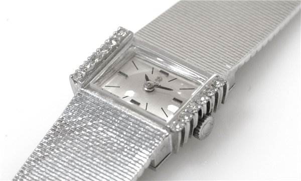 The image shows a close-up view of an Omega Women's White Gold Silver Dial Women's White Gold Silver Dial Vintage Ladies 18k Gold with Diamonds watch face and strap from an angled side perspective.