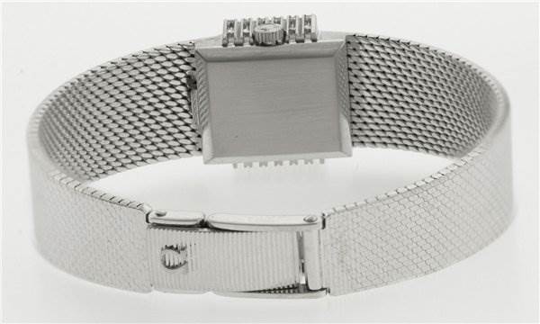 The image shows the back of the Vintage Ladies 18k White Gold with Diamonds model watch by Omega Women's White Gold Silver Dial Women's White Gold Silver Dial, featuring its clasp and mesh band.