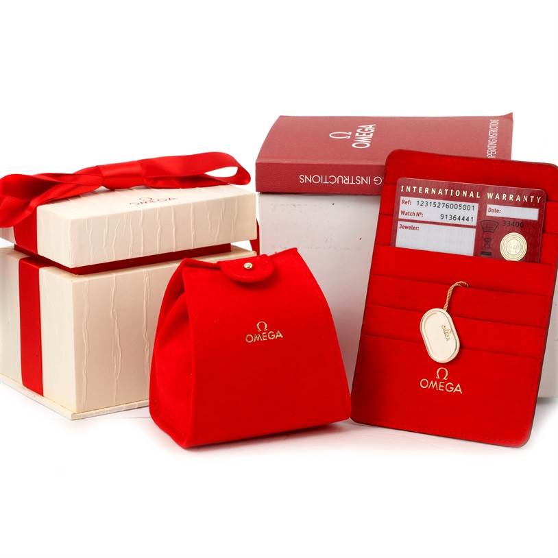 The image shows the packaging and accessories for the Omega 123.15.27.60.05.001 Women
s Stainless Steel Mother of Pearl Dial 123.15.27.60.05.001 Women
s Stainless Steel Mother of Pearl Dial Constellation 27mm Diamond Ladies Watch model 123.15.27.60.05.001.