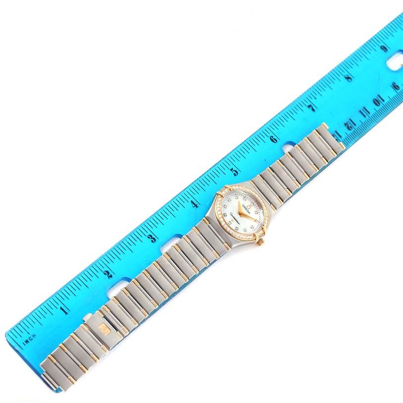 The Omega 1376.75.00 Women
s Steel and Gold (two tone) Mother of Pearl Dial 1376.75.00 Women
s Steel and Gold (two tone) Mother of Pearl Dial Constellation My Choice Steel Yellow Gold Diamond Watch 1376.75.00 is shown flat against a blue ruler, displaying its full band and face.
