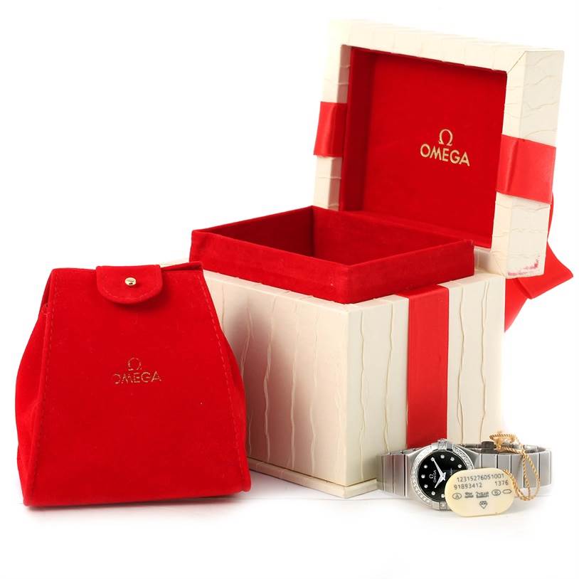 The image showcases the Omega 123.15.27.60.51.001 Women's Stainless Steel Black Dial 123.15.27.60.51.001 Women's Stainless Steel Black Dial Constellation 27mm Diamond Watch 123.15.27.60.51.001 with its packaging and accessories.