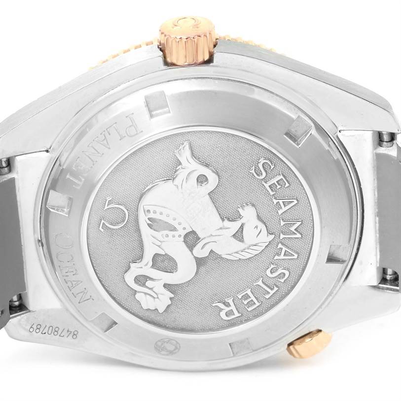 The image shows the back case and crown of the Omega 222.28.42.20.04.001 Women's Steel and Gold (two tone) White Dial 222.28.42.20.04.001 Women's Steel and Gold (two tone) White Dial Seamaster Planet Ocean 42 mm Diamond Watch 222.28.42.20.04.001.