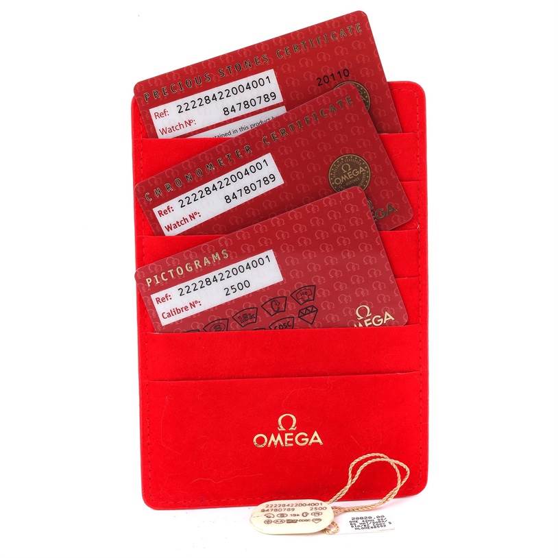 The image shows certification cards for the Omega 222.28.42.20.04.001 Women's Steel and Gold (two tone) White Dial 222.28.42.20.04.001 Women's Steel and Gold (two tone) White Dial Seamaster Planet Ocean 42 mm Diamond Watch 222.28.42.20.04.001 in a red holder.