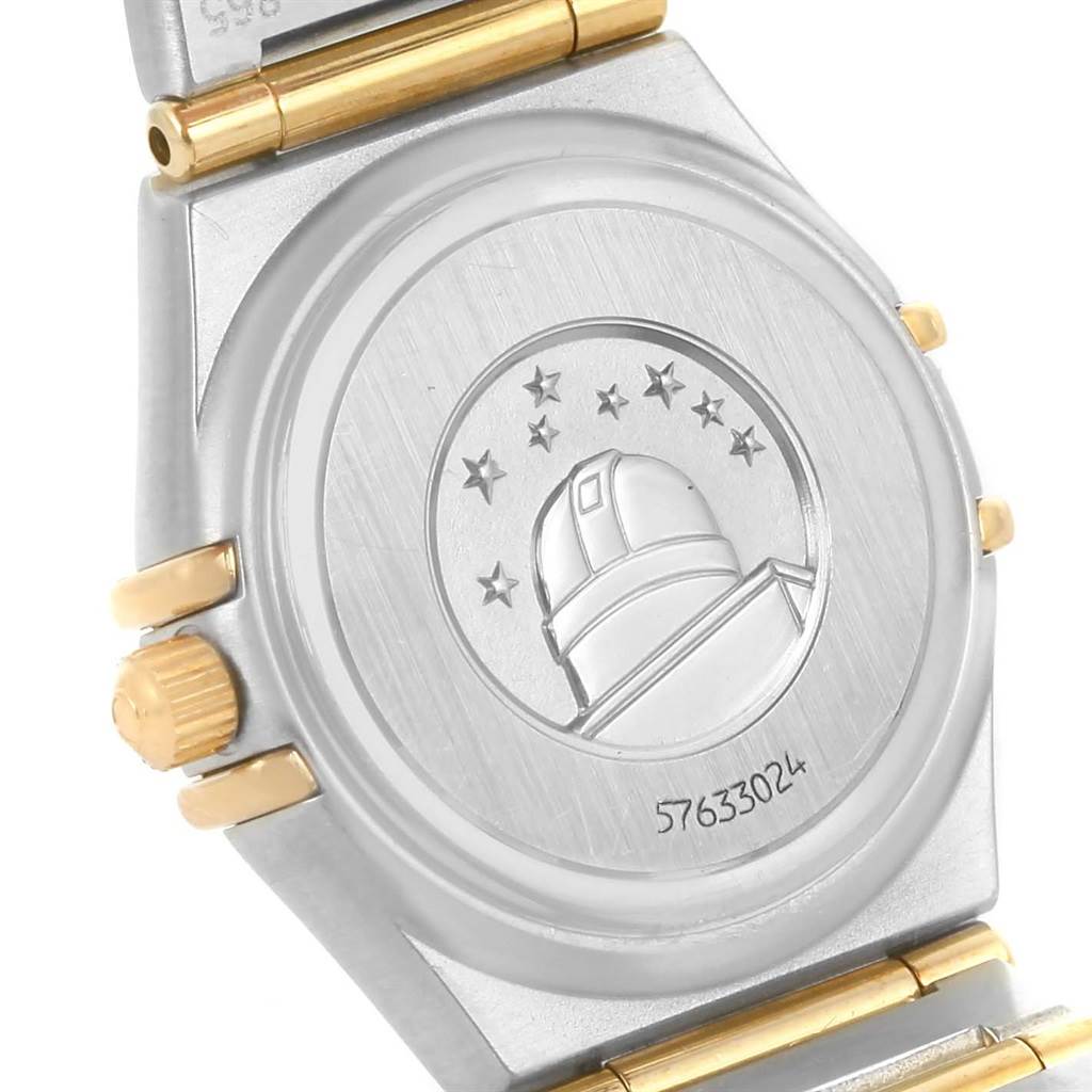 The image shows the case back and part of the bracelet of an Omega 1267.75.00 Women
s Steel and Gold (two tone) Mother of Pearl Dial 1267.75.00 Women
s Steel and Gold (two tone) Mother of Pearl Dial Constellation My Choice Mini Steel Gold Diamond Watch model 1267.75.00.