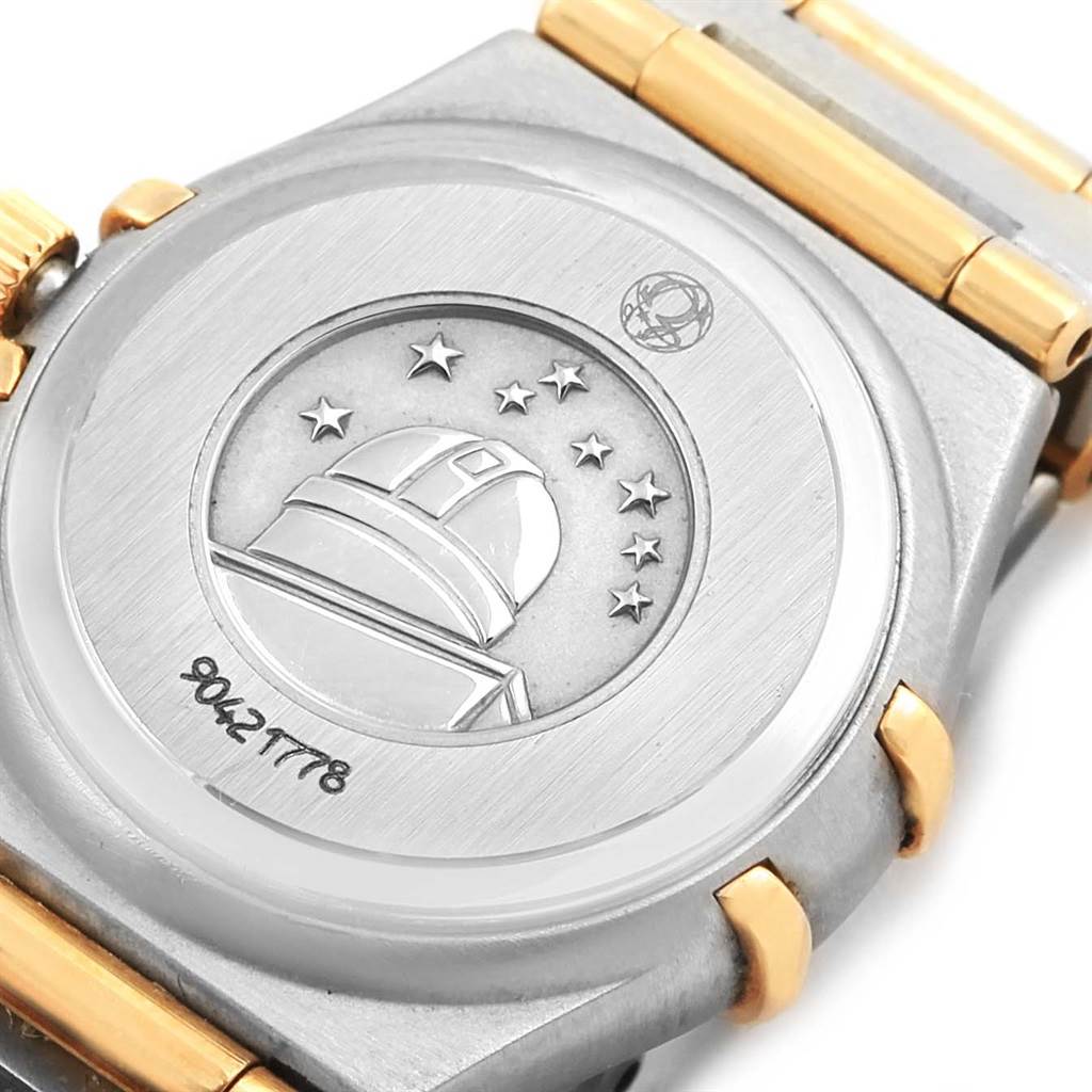 The image shows the back case of the Omega 1267.75.00 Women
s Steel and Gold (two tone) Mother of Pearl Dial 1267.75.00 Women
s Steel and Gold (two tone) Mother of Pearl Dial Constellation My Choice Mini Steel Gold Diamond Watch 1267.75.00, displaying engraving details.