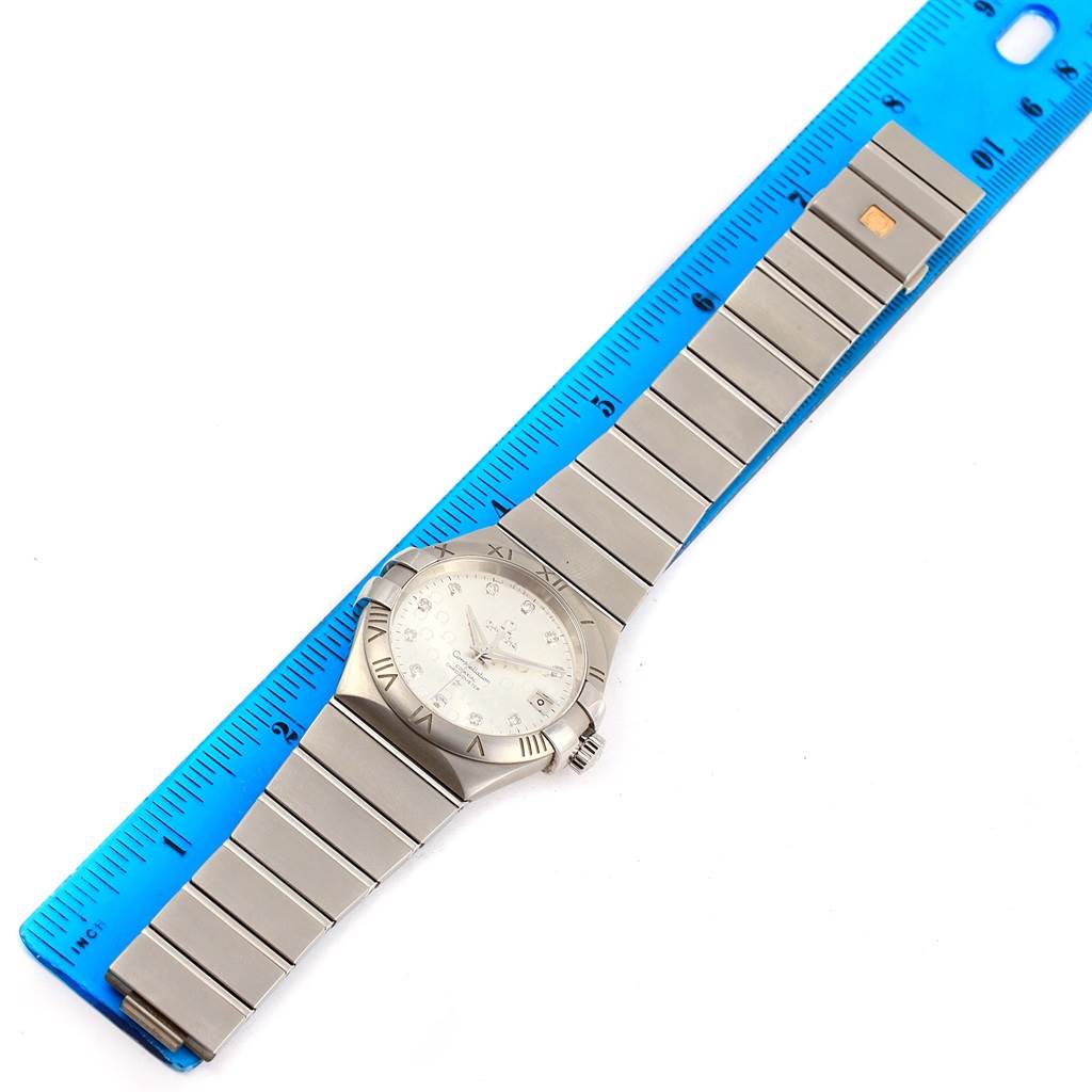 The Omega 123.10.35.20.52.002 Women
s Stainless Steel Silver Dial 123.10.35.20.52.002 Women
s Stainless Steel Silver Dial Constellation Steel Diamond Ladies Watch 123.10.35.20.52.002 is shown from a top angle with the band extended alongside a ruler.