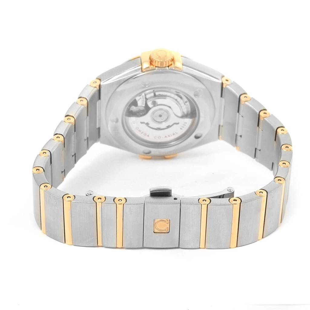 The image shows the back side and clasp of the Omega 123.25.31.20.58.001 Women
s Steel and Gold (two tone) Champagne Dial 123.25.31.20.58.001 Women
s Steel and Gold (two tone) Champagne Dial Constellation 31 Co-Axial Diamond Ladies Watch model 123.25.31.20.58.001.