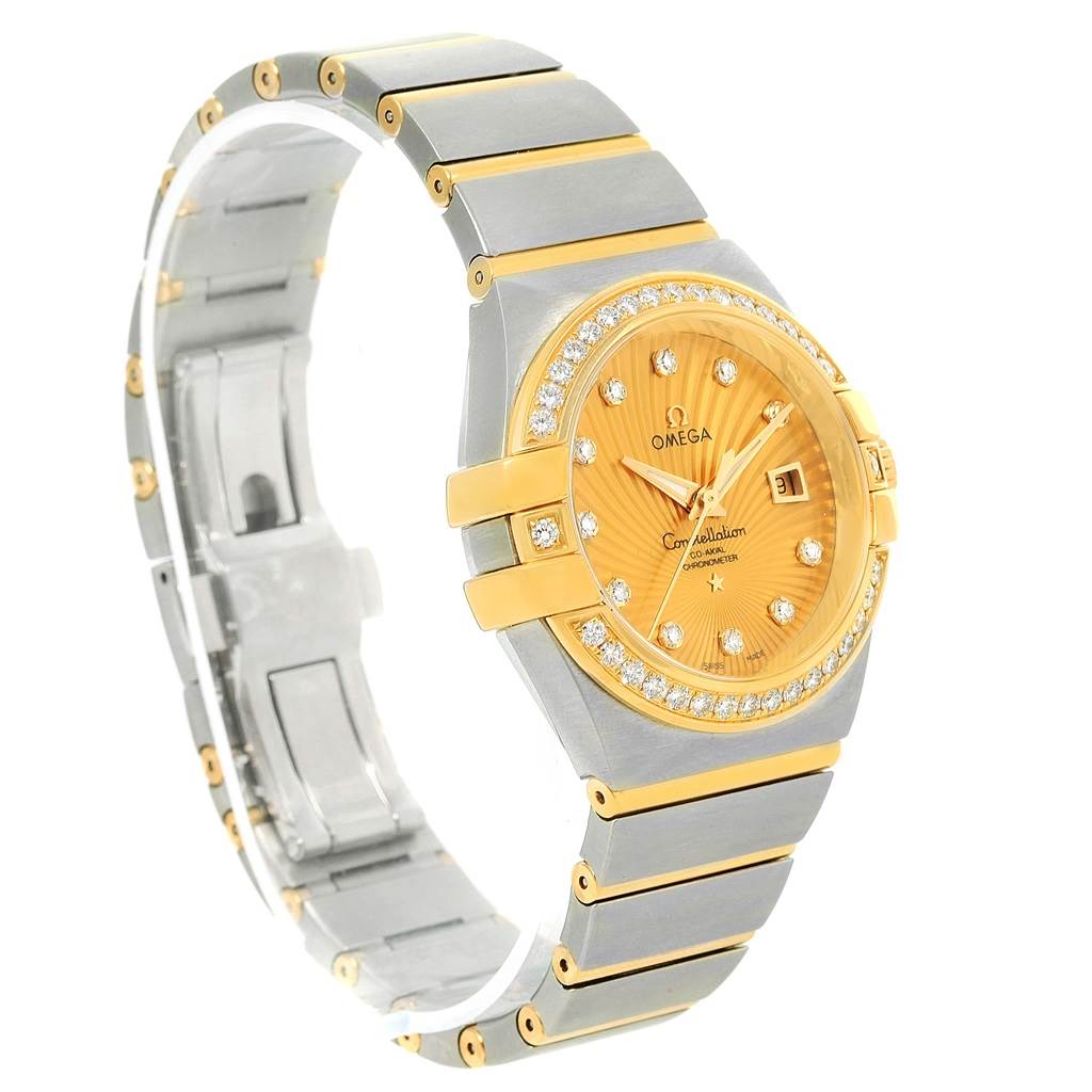 The Omega 123.25.31.20.58.001 Women
s Steel and Gold (two tone) Champagne Dial 123.25.31.20.58.001 Women
s Steel and Gold (two tone) Champagne Dial Constellation 31 Co-Axial Diamond Ladies Watch 123.25.31.20.58.001 is shown at an angle displaying the face, bezel, and bracelet.