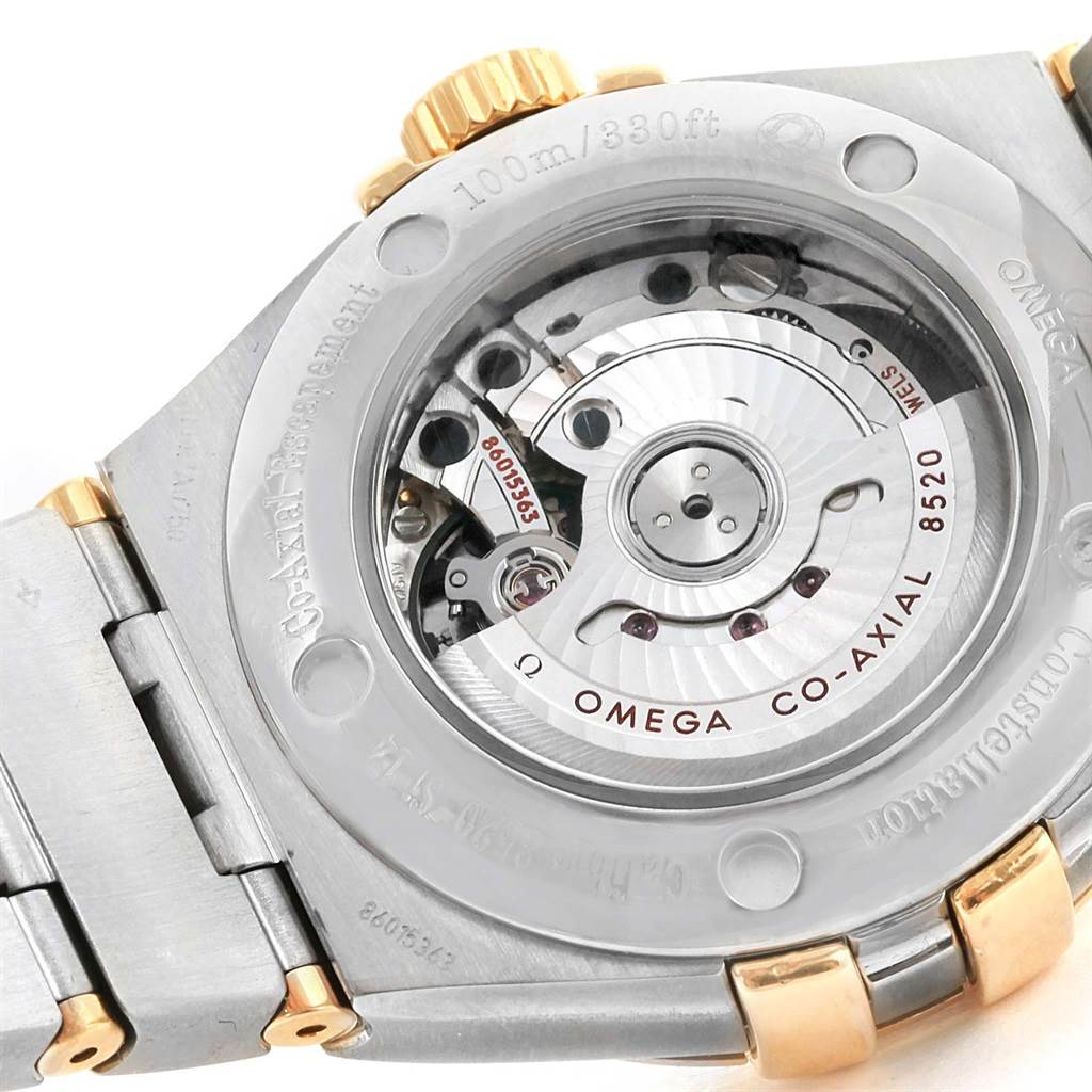 The image shows the back view of the Omega 123.25.31.20.58.001 Women
s Steel and Gold (two tone) Champagne Dial 123.25.31.20.58.001 Women
s Steel and Gold (two tone) Champagne Dial Constellation 31 Co-Axial Diamond Ladies Watch 123.25.31.20.58.001, highlighting its internal mechanism.
