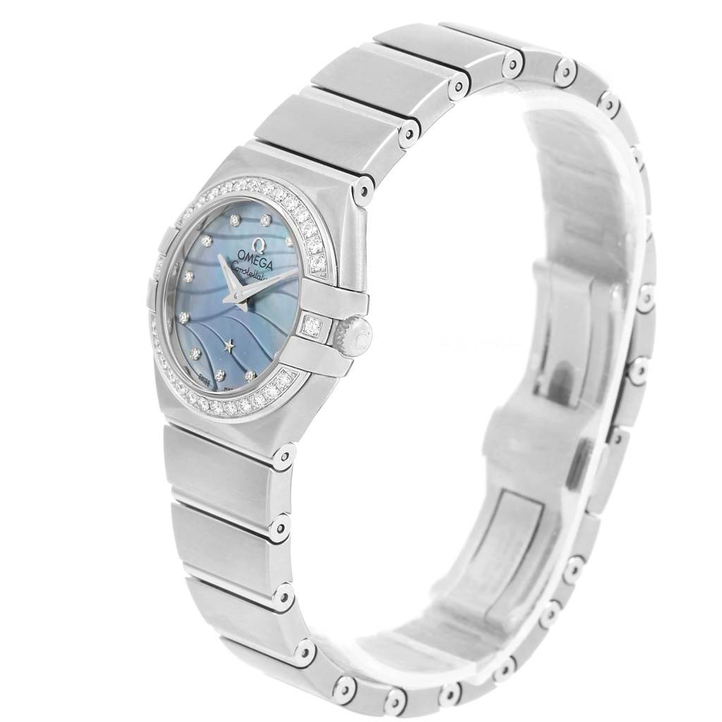 The image shows an angled view of the Omega 123.15.24.60.57.001 Women's Stainless Steel Mother of Pearl Dial 123.15.24.60.57.001 Women's Stainless Steel Mother of Pearl Dial Constellation Quartz 24 MOP Diamond Watch 123.15.24.60.57.001, highlighting its face, bezel, and bracelet.