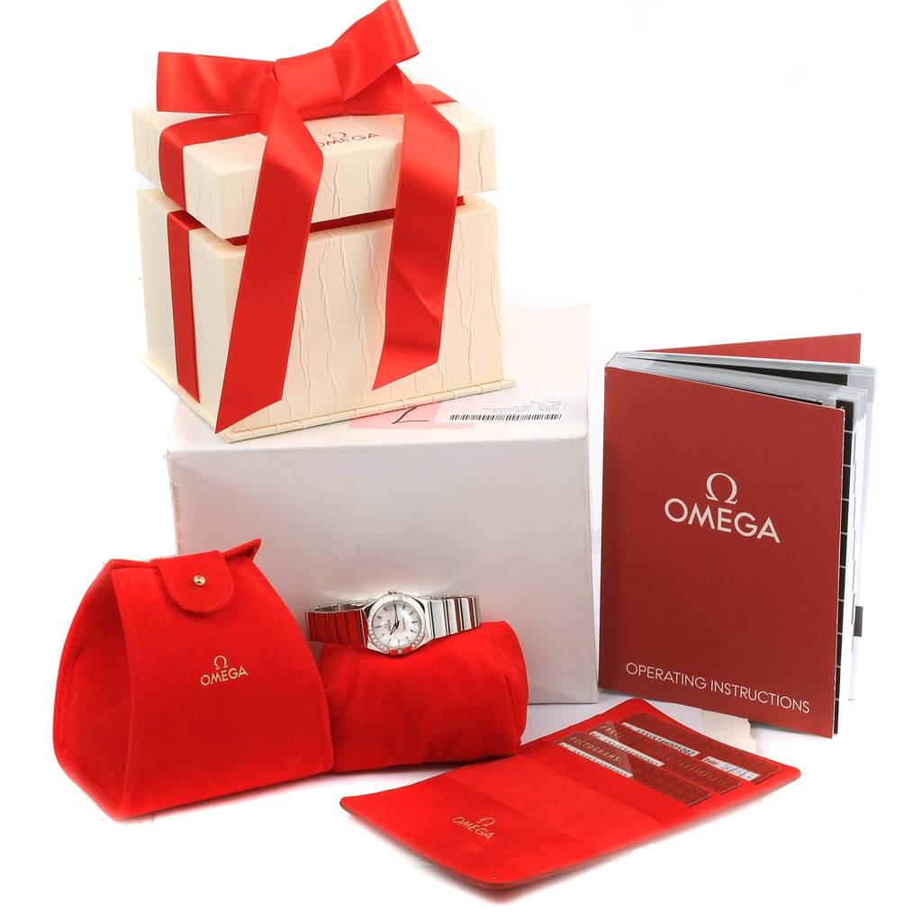 The image shows an Omega 123.15.24.60.05.002 Women's Stainless Steel Mother of Pearl Dial 123.15.24.60.05.002 Women's Stainless Steel Mother of Pearl Dial Constellation MOP Diamond Ladies Watch 123.15.24.60.05.002 with its box, red pouch, and operating instructions.