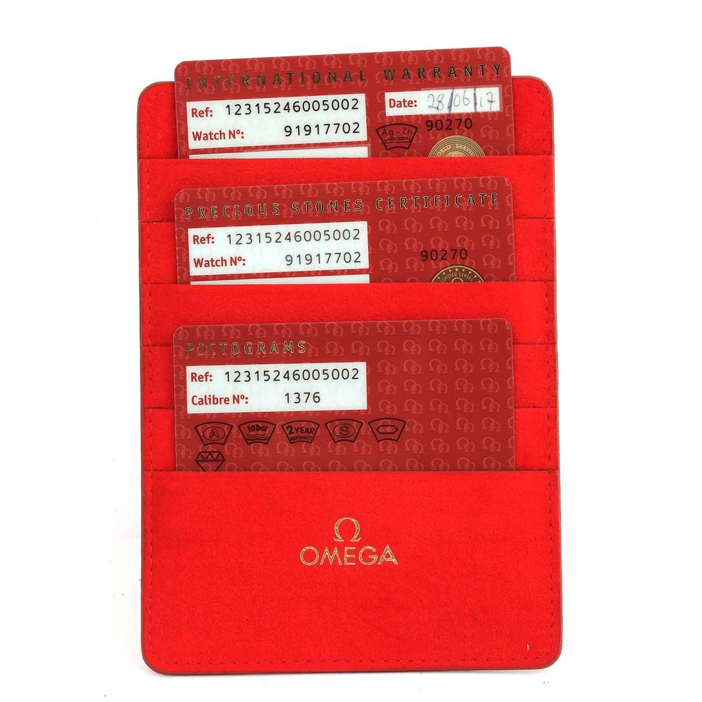 The image shows the warranty and certification cards for the Omega 123.15.24.60.05.002 Women's Stainless Steel Mother of Pearl Dial 123.15.24.60.05.002 Women's Stainless Steel Mother of Pearl Dial Constellation MOP Diamond Ladies Watch model 123.15.24.60.05.002 in a red holder.